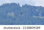 Small photo of Zeltweg Austria SEPTEMBER, 3, 2016 Military airplane in flight with green forest and mountains background. Mikoyan MiG29 Fulcrum of Polish Air Force. Copy space for News Title