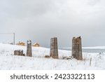 Small photo of War time concrete structure and yellow huts on a cloudy winter day during the polar night, Gornitak, Finnmark, Norway