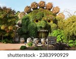 Small photo of TERRA BOTANICA, ANGERS, FRANCE - SEPTEMBER 24, 2023: Head of a monster covered with ivy in a park landscape design. Grass figure