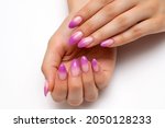 Ombre on the nails. French lilac manicure on long oval nails on a white background close-up.