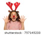 Pretty little girl with Christmas antlers on her head and red Rudolph the reindeer nose screaming excitedly isolated copyspace party celebration x-mas new year family emotions costume Santa Claus