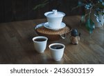 Small photo of Chinese tea ceremony Asian pressed pu erh top view copy space morning energy. Breakfast puer hot drink with caffeine fermented dark crockery tea set ceramic pot cups