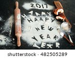 New year 2017 inscription of flour on the table, cut out the letters with the broken bread, and rocking sieve
