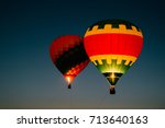 Glowing and blinking balloons flight with people high in sky in night. Freedom concept. Romantic recreation. Hot air balls competition. Autumn ballooning festival. Travel and tourism. Airship journey.