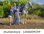 Small photo of Family with children on walk a horse