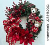 Small photo of A Christmas wreath usually consists of holly, berries and mistletoe. Wreaths are made into a circular shape and generally hung outside the house. Wreaths are made from tree leaves and are a symbol of