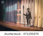 Small photo of Tin Soldier, Russian foot artillery gunner 1812-1815, year on a bookshelf.