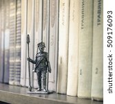 Small photo of City Udomlya, Russia - December 26, 2013: Tin Soldier, Russian foot artillery gunner 1812-1815, year on a bookshelf