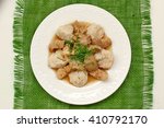 Goulash with oyster mushroom and buckwheat dumplings on the plate on the green gunny cloth, overhead horizontal view