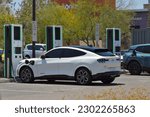 Small photo of Chandler, Arizona - May 12 2023: A new Ford Mustang Mach-E GT X Electric vehicle parking at Electrify America EV charging stations offered to customers at the Phoenix Premium Outlets shopping center.