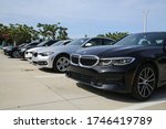 Small photo of FORT LAUDERDALE, FLORIDA/USA - MAY 31 2020 - Different color BMWs line up the parking lot in the afternoon sun at the dealership on 2601 S. Andrews Avenue