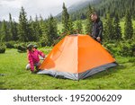 Young Family Pithing Tent In...