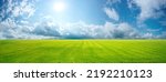 Small photo of Beautiful natural scenic panorama green field of cut grass into and blue sky with clouds on horizon. Perfect green lawn on summer sunny day.
