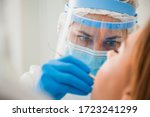 Young female dentist curing patient's teeth filling cavity. Stomatologist working with professional equipment in clinic office. Close-up shot, teeth care and medicine concept