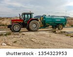 Small photo of Torrevieja, Alicante, Spain - March 26 2009 : Masey Ferguson tractor towing diesel tanker on builing site in Spain
