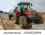 Small photo of Torrevieja, Alicante, Spain - March 26 2009 : Masey Ferguson tractor towing diesel tanker on builing site in Spain