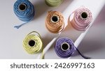 Small photo of Colorful industrial textile yarns. Wool yarn spools. Colorful orlon yarn spool.