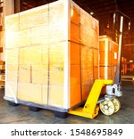 Small photo of Hand pallet truck with stacked package boxes on pallet, cargo export shipment
