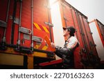 Small photo of Truck Driver is Checking Container Door. Security of Cargo Shipping. Semi Truck Maintenance. Inspection Safety Before Driving. Freight Truck Logistics Transport.