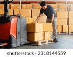 Small photo of Warehouse Workers Lifting Package Boxes Stack on Pallet. Cartons, Cardboard Boxes. Supply Chain, Shipment Boxes, Shipping Supplies Warehouse Logistic