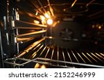 Small photo of oven in the oven close-up. Inside a new empty electric open oven with light.