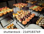 light snacks for the holiday, catering. Various light snacks. Catering plate. Assortment of sandwiches on the buffet table. meat, fish, vegetable canapes.