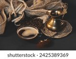 Small photo of A steaming coffee mug, golden coffee pot, and scattered beans: A warm tableau, the essence of a comforting coffee ritual.