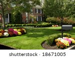 Traditional brick colonial dressed up for fall with colorful mums