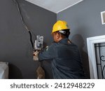 Small photo of PLN officers are replacing electricity meters... migrating from postpaid to prepaid... Bekasi, Indonesia... 1,15,2024