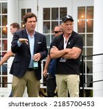 Small photo of BEDMINSTER,NJ-JULY 31,2022: Tucker Carlson (L) talks to Greg Norman at the 16th Hole during the final LIV Golf Tournament held at the Trump National Golf Club in Bedminster,NJ.