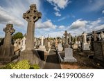 Small photo of Dublin, Ireland - July 8 2023: Embark on a poignant visual journey with this compelling photo capturing a Catholic cemetery in Dublin during the embrace of daylight.