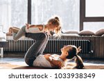 Mother and daughter yoga at home
