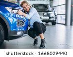 Young Woman Hugging A Car In A...