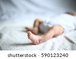 foot of a newborn who is sleeping peacefully in the crib