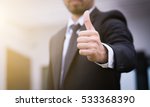 Businessman showing thumbs up   ...