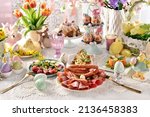 Small photo of Easter breakfast with a plate of sliced ham, salami and sausages, fresh salads and stuffed eggs