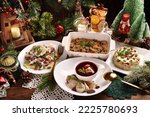 Christmas Eve's red borscht soup with mushroom filled ravioli and other traditional dishes on festive table