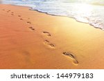 Beach  Wave And Footsteps At...
