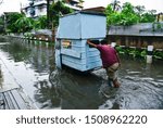 Small photo of Guwahati, Assam, India. 17 September 2019. Commuters wade through flooded street after heavy rainfall in Guwahati.