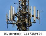 Telecommunication tower of 4G and 5G cellular. Macro Base Station. 5G radio network telecommunication equipment with radio modules and smart antennas mounted on a metal on blue sky background.     