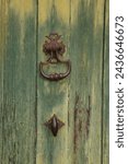 Small photo of wooden green door with nice antic door-handles
