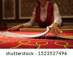 Small photo of The croupier in the casino does a shuffle of cards