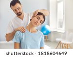 Small photo of Licensed chiropractor or manual therapist doing neck stretch massage to relaxed female patient in clinic office. Young woman with whiplash or rheumatological problem getting professional doctor's help