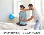 Small photo of Osteopathic medicine and physiotherapy. Licensed osteopath examining young woman in modern hospital office. Chiropractor helping female patient with scoliosis, low back pain or other spine problems