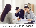 Small photo of Financial problems. Couple getting very bad news from real estate agent, bank manager or lawyer. Sad clients reading bankruptcy notice or mortgage contract with disadvantageous terms and conditions