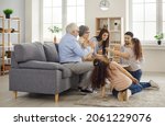 Small photo of Grandparents come to visit. Happy multi generational family playing board game at home. Mom, dad, granny, granddad, children gather in modern living room, build tumble tower, enjoy good time together