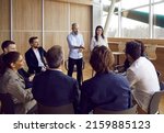 Small photo of Team of people meeting with business coach. Experienced trainer talking to group of office workers, making convincing speech about motivation and skills, asking questions, sharing knowledge and advice