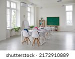 Small photo of Classroom school.Interior of clean spacious classroom ready for new school year. Empty room with white walls, comfortable desks, chairs, green blackboard, whiteboard. Back to school.