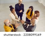 Small photo of Top view of businessman handshake ethnic female partner congratulate with work success. Young African American woman get acknowledgement from colleagues. Boss greeting coworker with promotion.