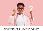 Small photo of Smart clever intelligent casual young adult lady with question mark finds inspiration, has good idea, knows answer, smiles, points up, solves test puzzle quiz, shares important women's health advice